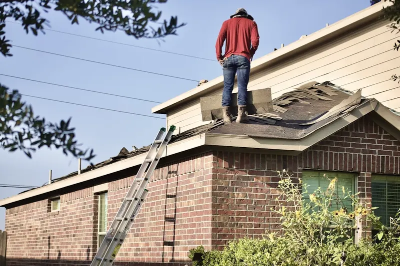 Professional roofer working on a residential roof in Leisure Woods